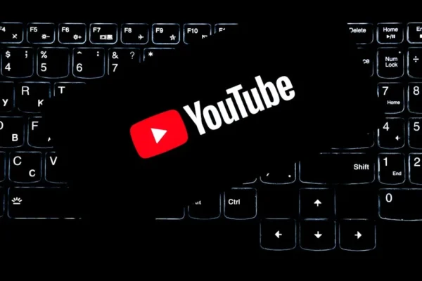YouTube logo displayed on a backlit keyboard, representing digital media and online content creation.