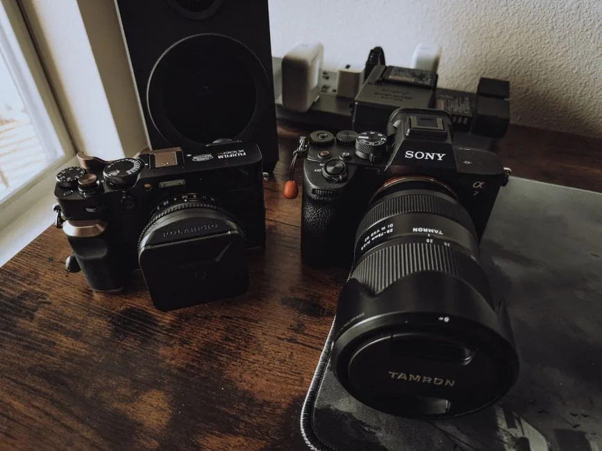 High-quality image of professional cameras on a wooden desk, perfect for stock use.